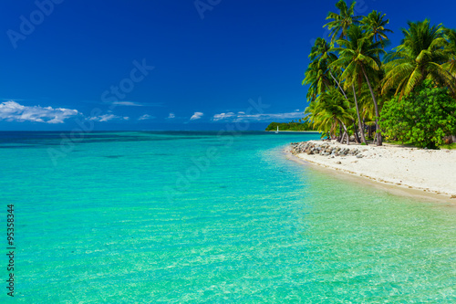 Fiji island with sandy beach and clear lagoon water