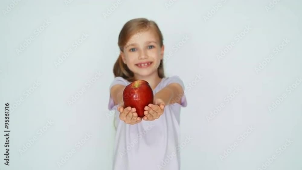 Child showing apple. Girl holding a red apple in the palm Child showing apple. Girl holding a red apple in the palm