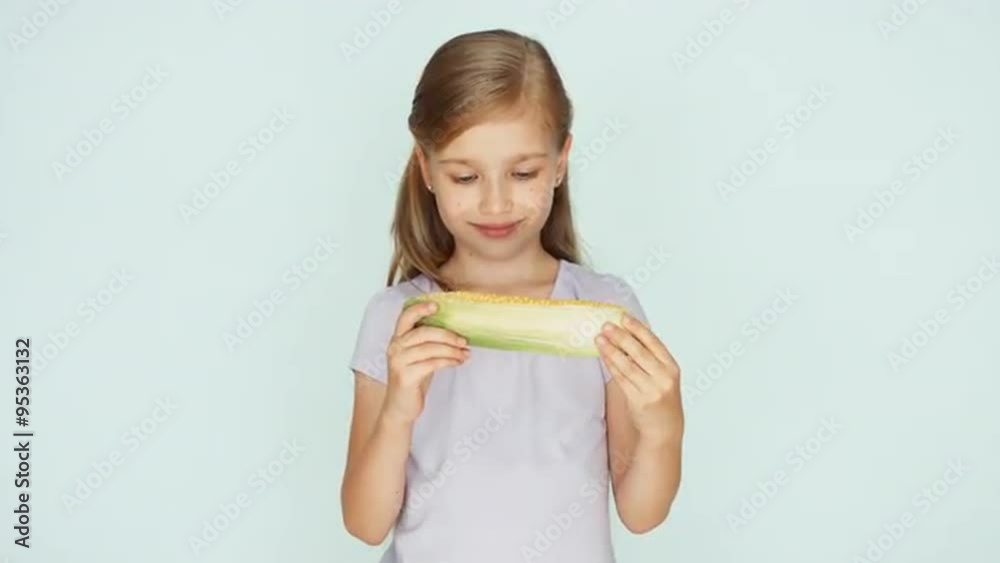 Child showing corn. Girl holding corn in the hands Child showing corn. Girl holding corn in the hands