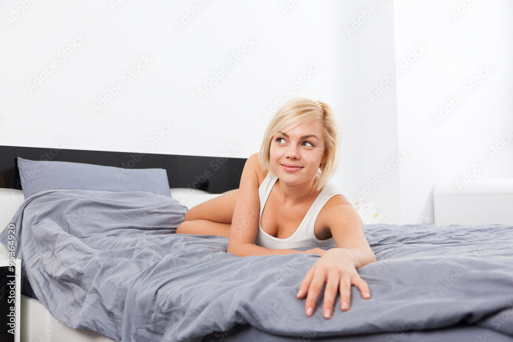 Beautiful woman lying on bed home Beautiful woman lying on bed home