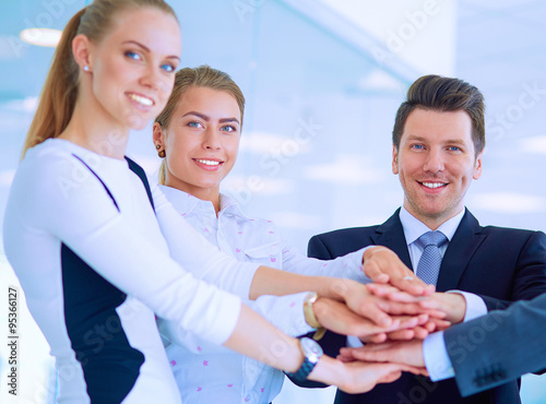 Business people with their hands together in a circle