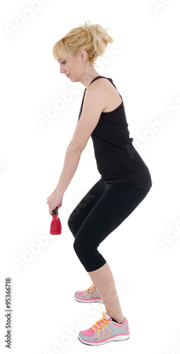 Woman against white background with kettle bell..