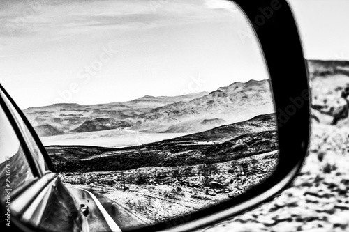road trip in the middle of the desert in summer in black and white