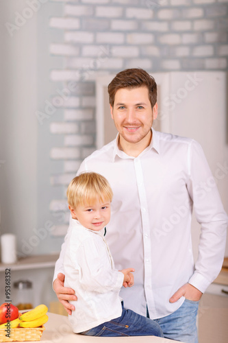  Father and son are posing together.