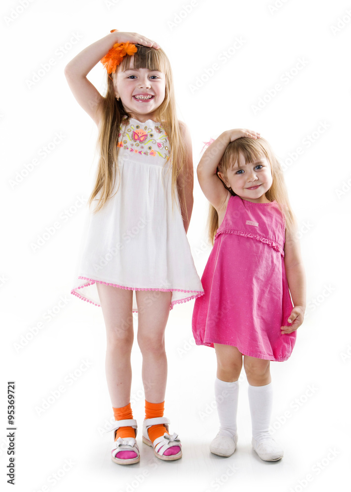 the little girls in a pink dress and white dress the same unison poses ...