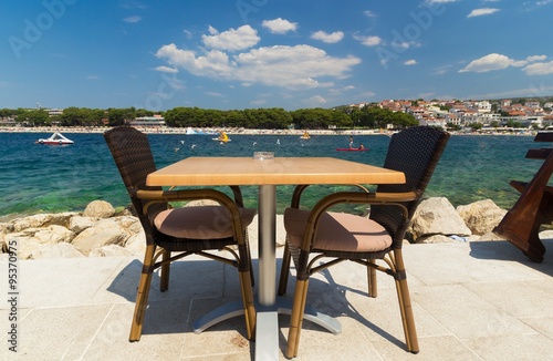 Restaurant table waiting for customers by the Adriatic sea