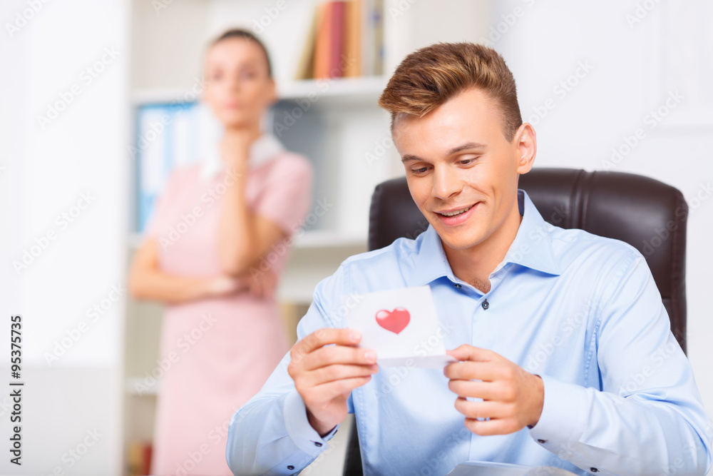 Fototapeta premium Male executive looks delighted while reading the note.