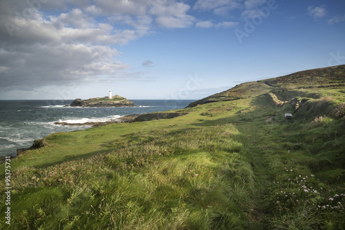 Beautiful sunrise landscape image of Godrevy in Corwnall England