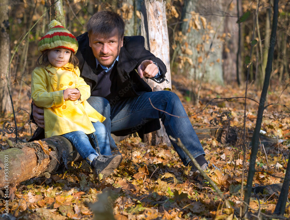 European Family Father and Little Baby Girl sitting in Autumnal Forest Pointing on something Watching and Looking European Family Father and Little Baby Girl sitting in Autumnal Forest Pointing on something Watching and Looking