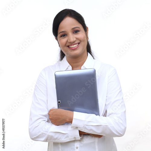 Happy young business woman holding tablet computer