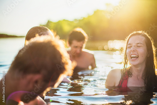Teenagers having fun and bathing in the lake during a sunny day © jackfrog