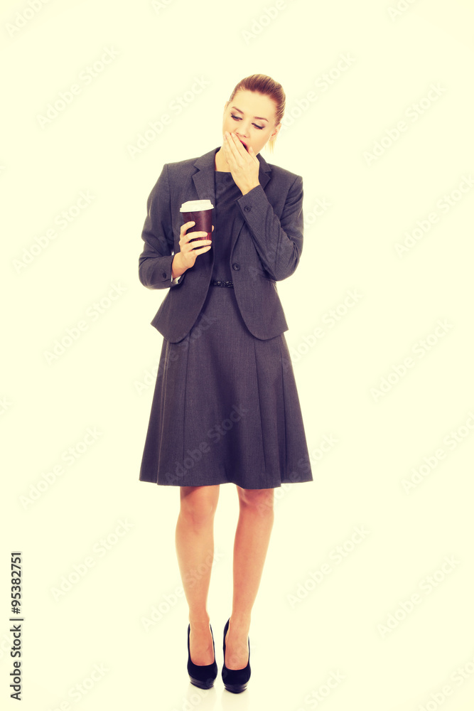 Tired businesswoman with a coffee. Tired businesswoman with a coffee.