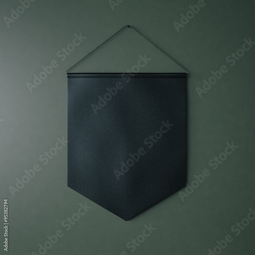 Black pennant hanging on the green bricks wall at background. 3d render