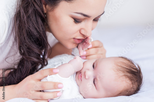 Young happy beautiful mother with her little baby