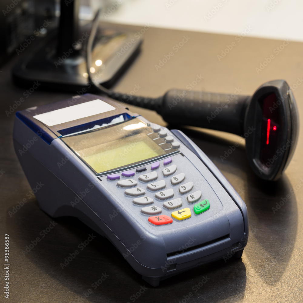 Credit Card Machine with Barcode Scanner in Background at the st