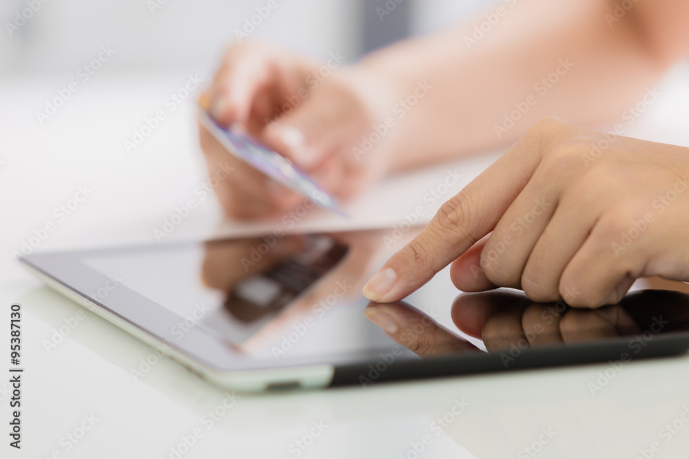 Woman shopping using tablet pc and credit card Woman shopping using tablet pc and credit card