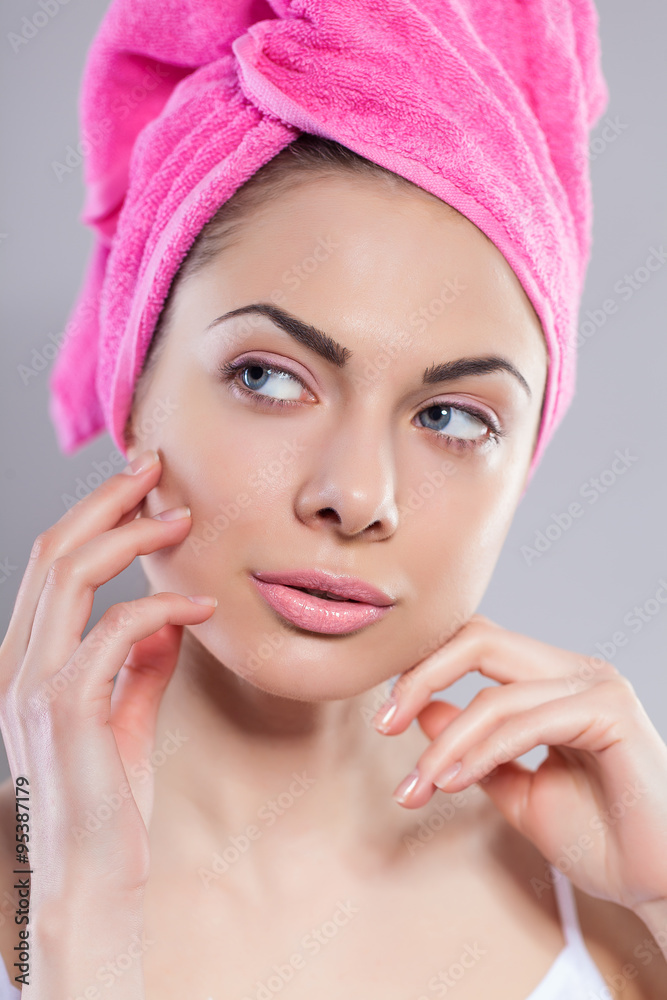 Portrait of young woman with perfect health skin of face and bath towel on head Portrait of young woman with perfect health skin of face and bath towel on head