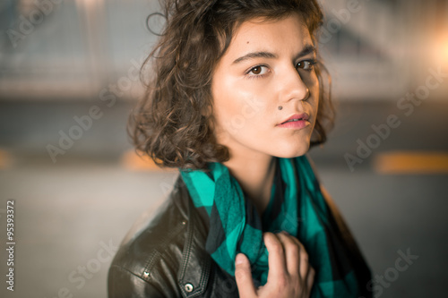 Beautiful young girl with a thoughtful face quietly looking into the camera. Soft focus
