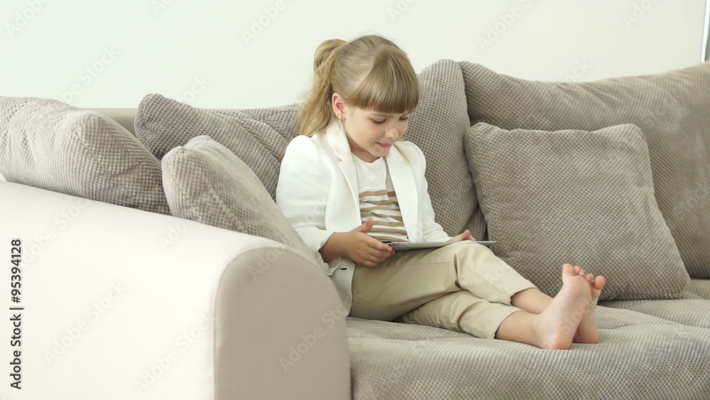 Cute business lady sitting on sofa with tablet Cute business lady sitting on sofa with tablet