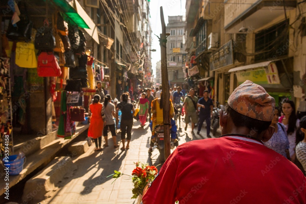 Rikshaw driver on a busy street.