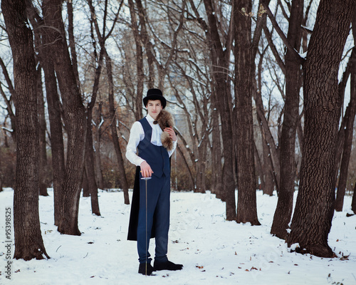 Handsome  elegantyoung man with rapier, outdoor photo