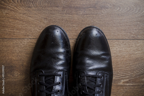 Brown leather shoes on a wooden floor 