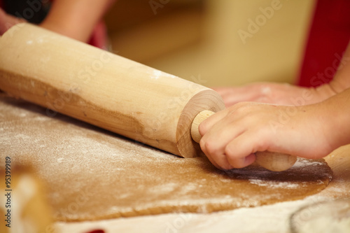 Working on unfinished dough with a rolling pin