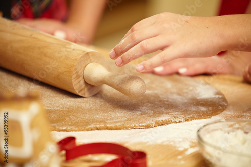 Working on unfinished dough with a rolling pin