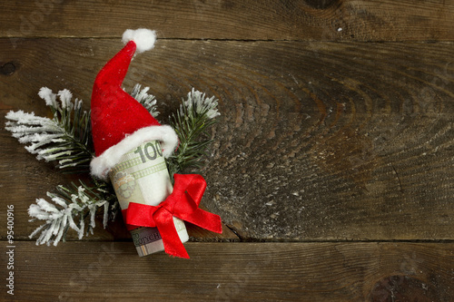 Obraz na płótnie Gift money with red ribbon and Santa cap w salonie