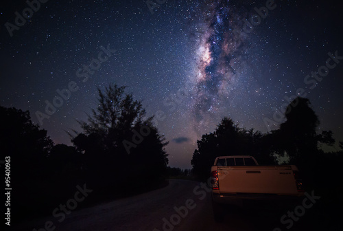 milky way above a pick up thad parking at the road side