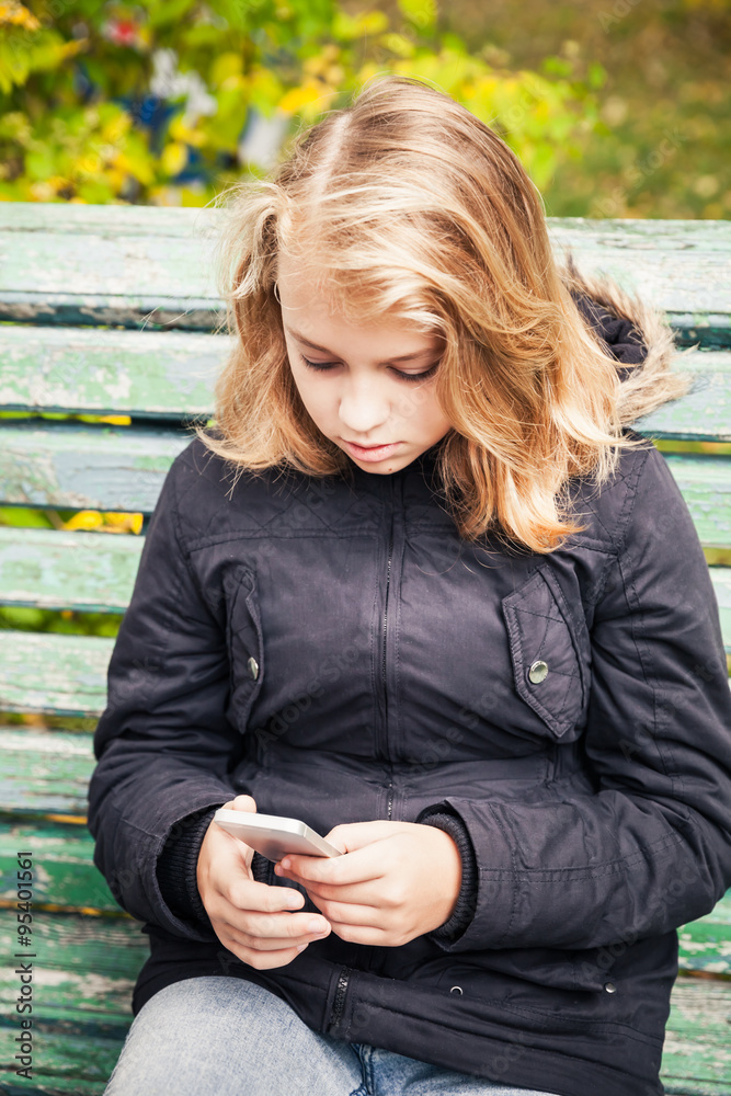 Beautiful blond teenage girl with smartphone Beautiful blond teenage girl with smartphone