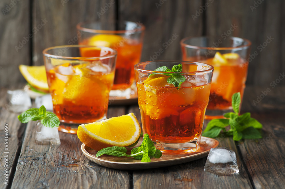 Glass of aperol with ice, orange and mint Glass of aperol with ice, orange and mint