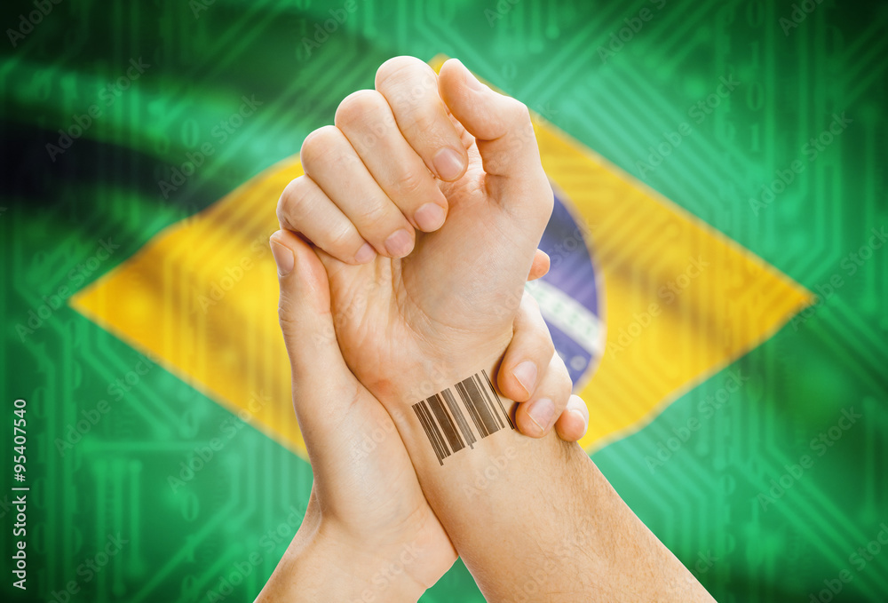 Barcode ID number on wrist and national flag on background - Brazil