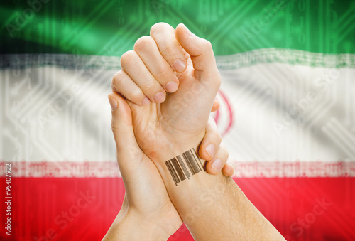 Barcode ID number on wrist and national flag on background - Iran