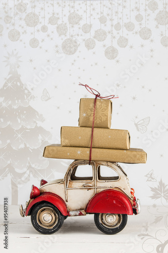 Christmas holiday card with gift boxes on toy car