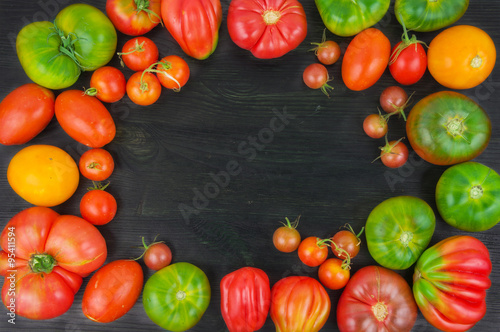ripe tomatoes on wood background