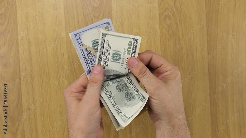 Counting dollars over the desk Counting dollars over the desk