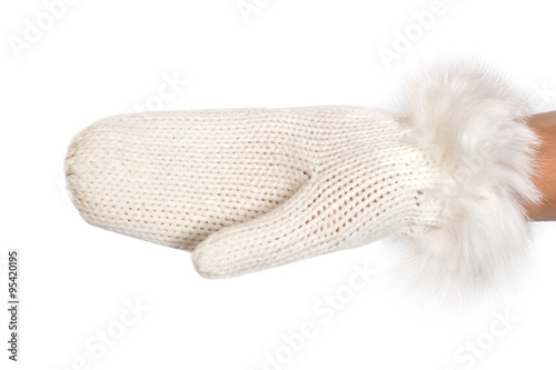 Woman hand in a white warm knitted mitten