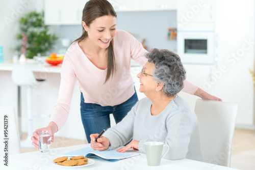Carer helping woman at home