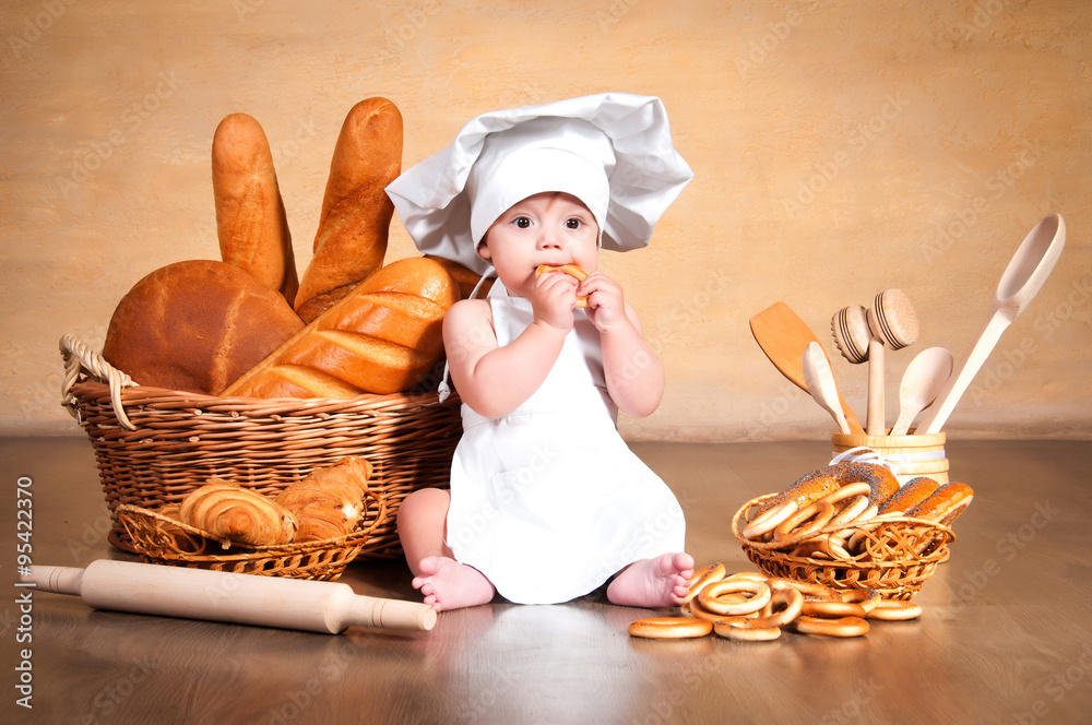 Little cook with a bagel in her hands. Little cook with a bagel in her hands.
