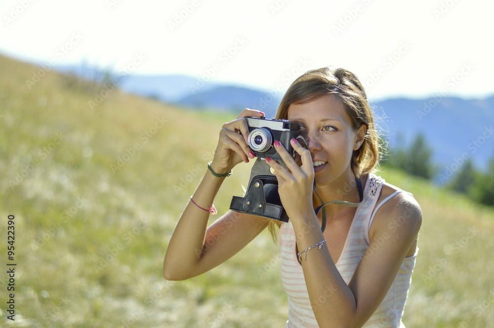 Young and beautiful woman holding a retro camera Young and beautiful woman holding a retro camera