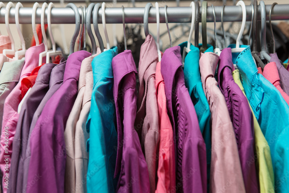 Clothes hang on a shelf in a designer clothes store Clothes hang on a shelf in a designer clothes store