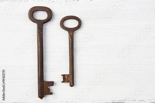 Set of vintage door keys on wooden background © Sensay