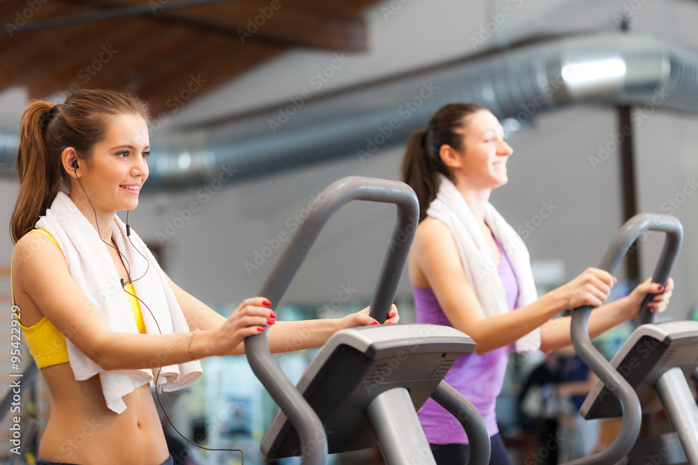 Fototapeta premium Women using a treadmill to run in a gym