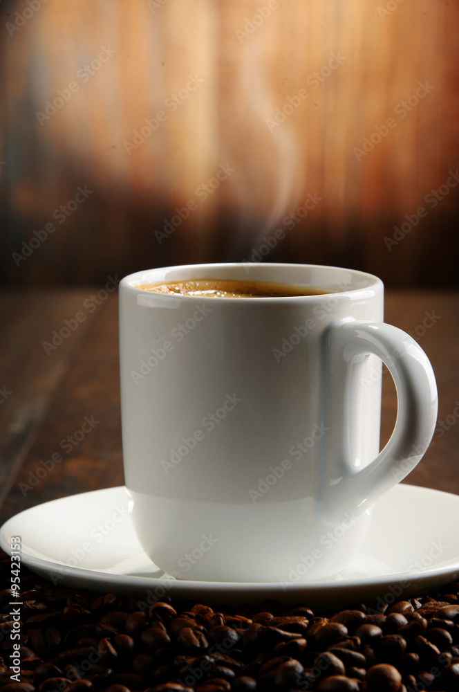 Composition with white cup and coffee beans Composition with white cup and coffee beans