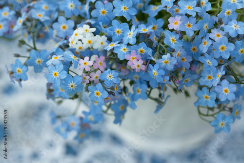 Photo Forget-me-not flowers in a vase, close-up, fragment, blur.