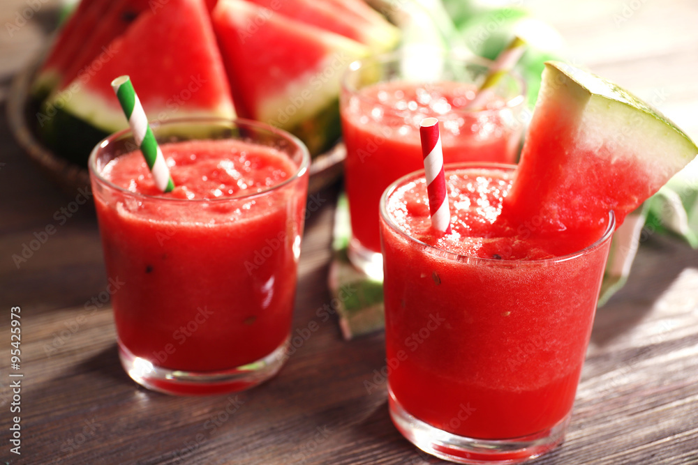 Glasses of watermelon juice on wooden table, closeup Glasses of watermelon juice on wooden table, closeup