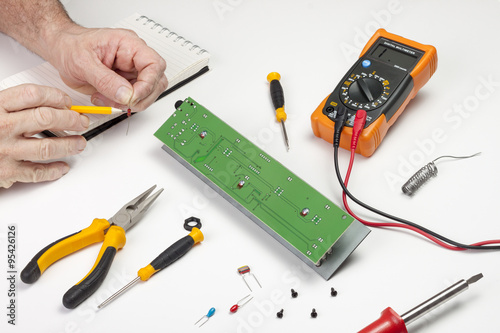 Electronics engineer checking the value of a resister component