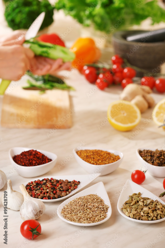 Variety of spices in ceramic containers on the kitchen table Variety of spices in ceramic containers on the kitchen table