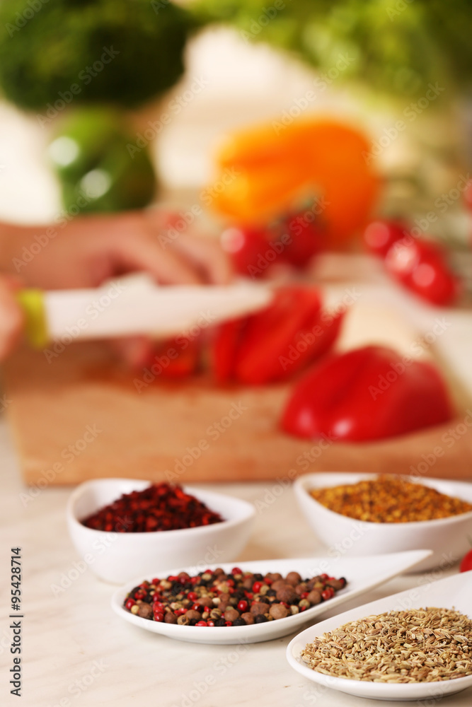 Variety of spices in ceramic containers on the kitchen table Variety of spices in ceramic containers on the kitchen table
